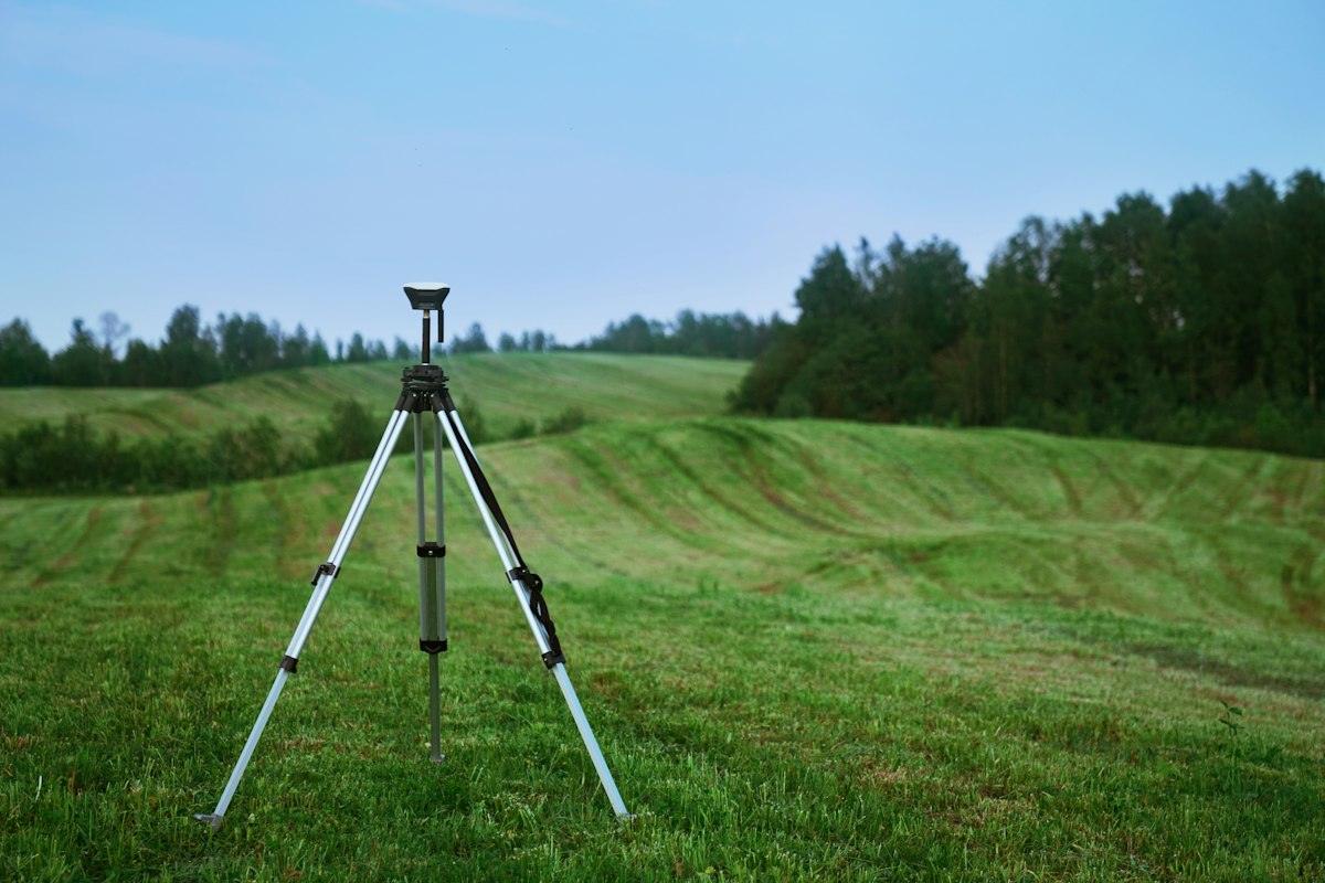 A survey tripod standing in a field