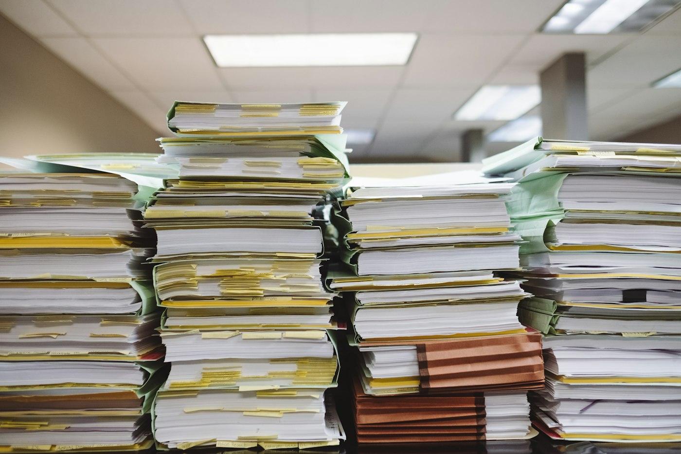 Stacked paper documents and folders